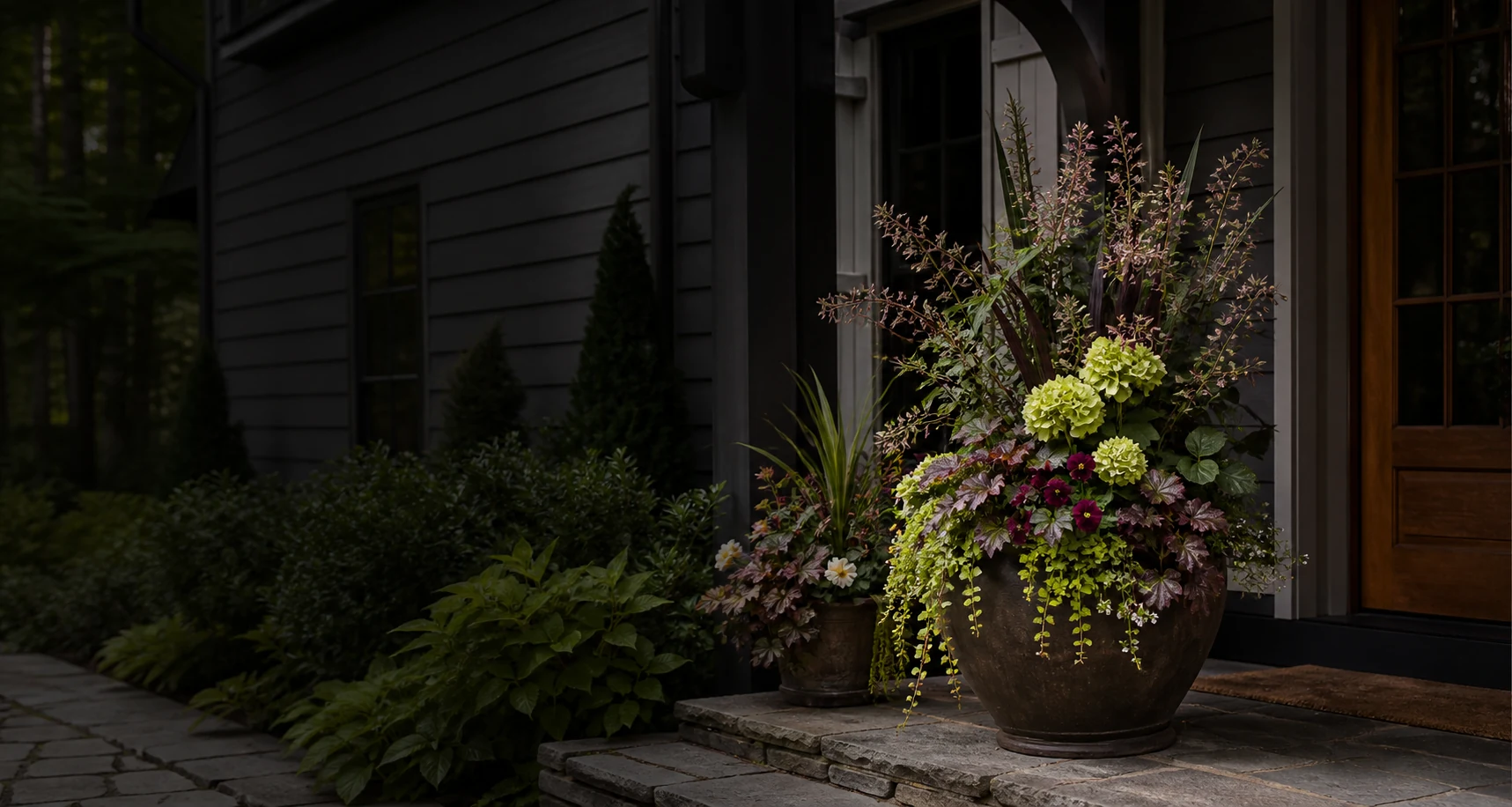Layered custom container planting at a refined Western North Carolina home entrance
